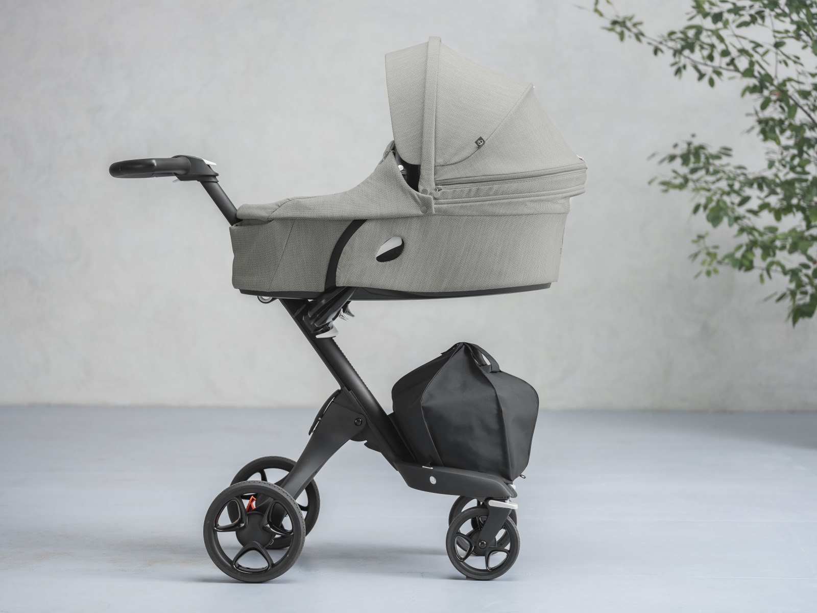 Stokke&reg; Xplory&reg; with Black Chassis and Stokke&reg; Xplory&reg; Carry Cot, Brushed Grey.
